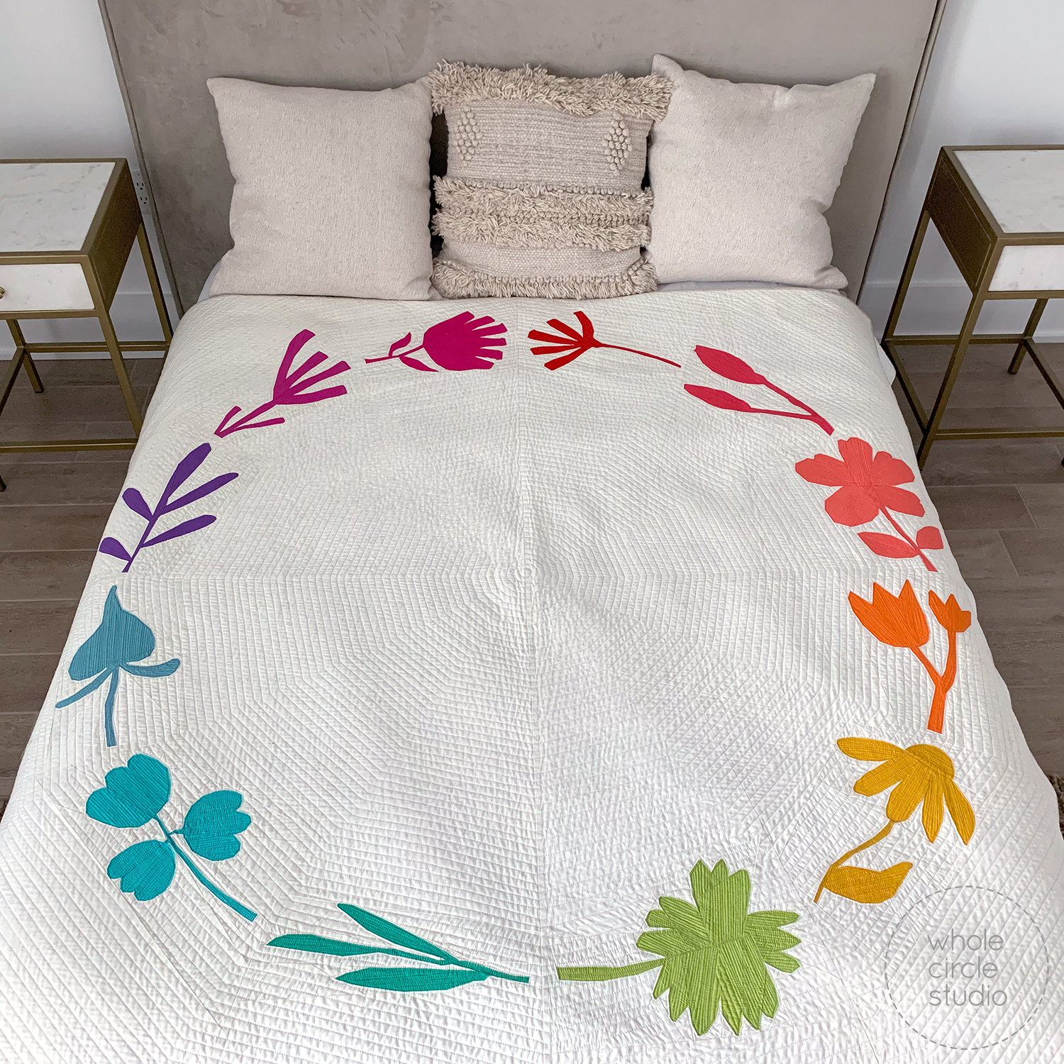 bed with colorful Botanical themed quilt